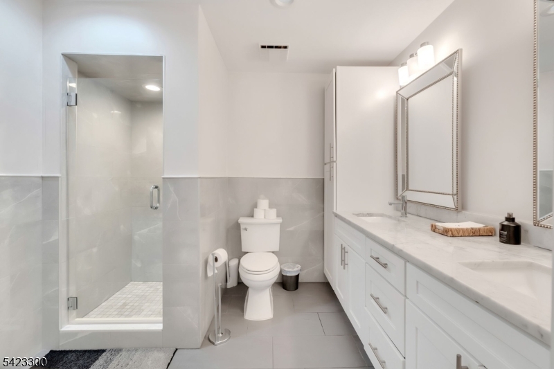 16 East Greenbrook Road North Caldwell, NJ 07006 - Photo 22 of 45 a spacious bathroom with a double vanity sink toilet and shower