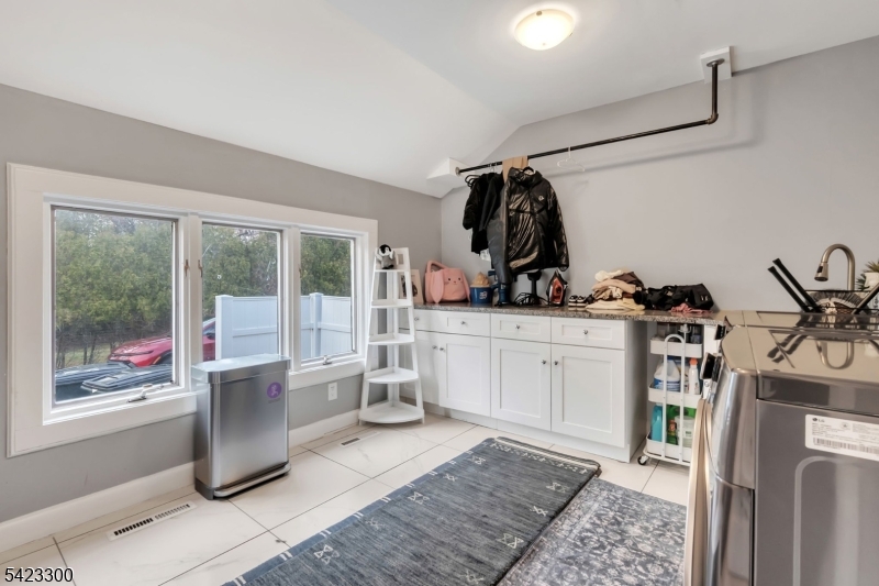 16 East Greenbrook Road North Caldwell, NJ 07006 - Photo 27 of 45 a room with white cabinets and white appliances