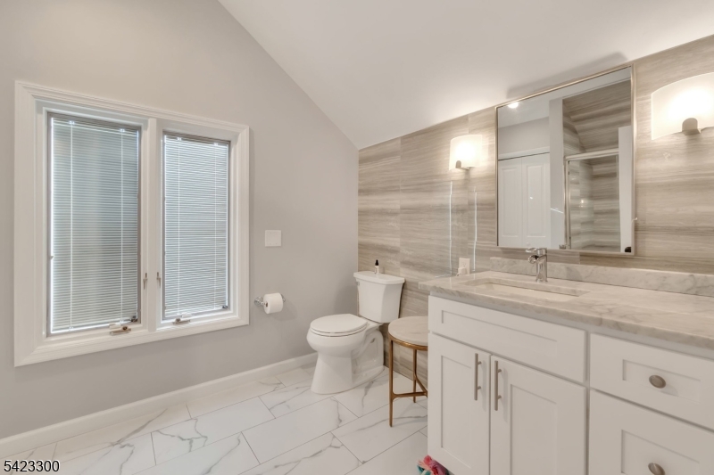 16 East Greenbrook Road North Caldwell, NJ 07006 - Photo 29 of 45 a bathroom with a granite countertop sink toilet and shower