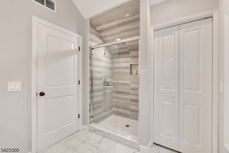16 East Greenbrook Road North Caldwell, NJ 07006 - Photo 30 of 45 a bathroom with a glass shower door