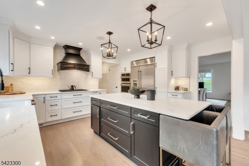 16 East Greenbrook Road North Caldwell, NJ 07006 - Photo 8 of 45 a kitchen with stainless steel appliances kitchen island granite countertop a sink a stove and cabinets