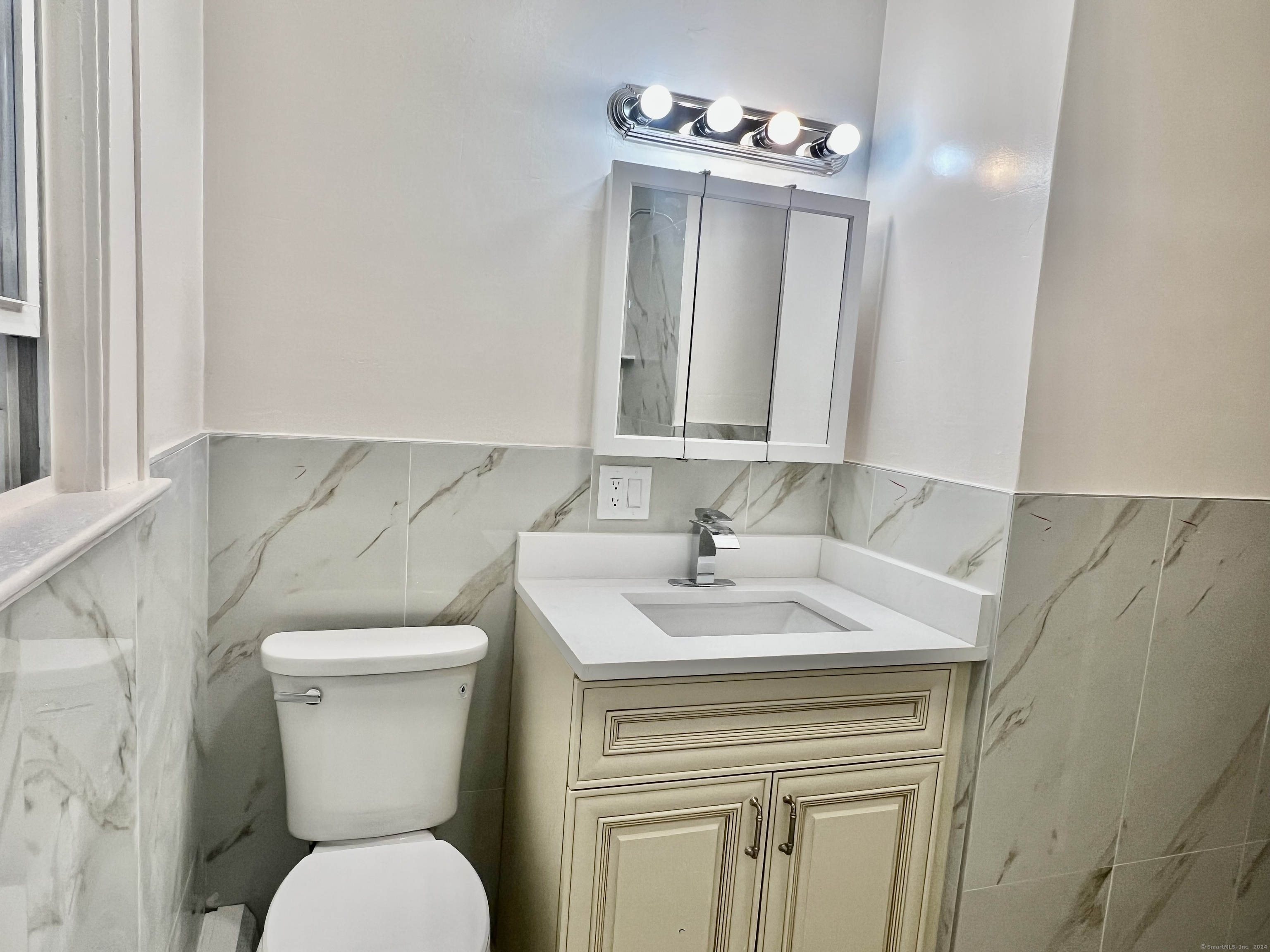 38 Wilson Street Stamford, CT 06902 - Photo 16 of 30 a bathroom with a toilet sink and mirror