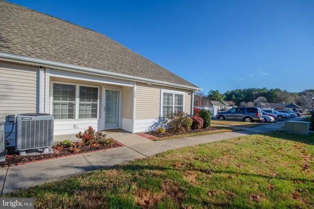 a front view of a house with patio furniture and garden