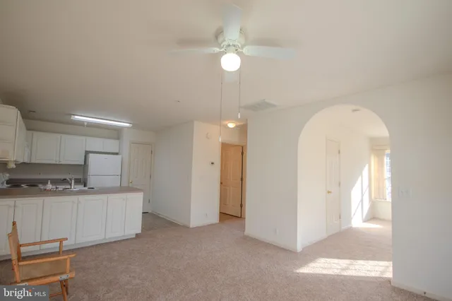 a kitchen with a sink a refrigerator and cabinets