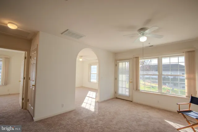 a view of a sink and dishwasher with white cabinets