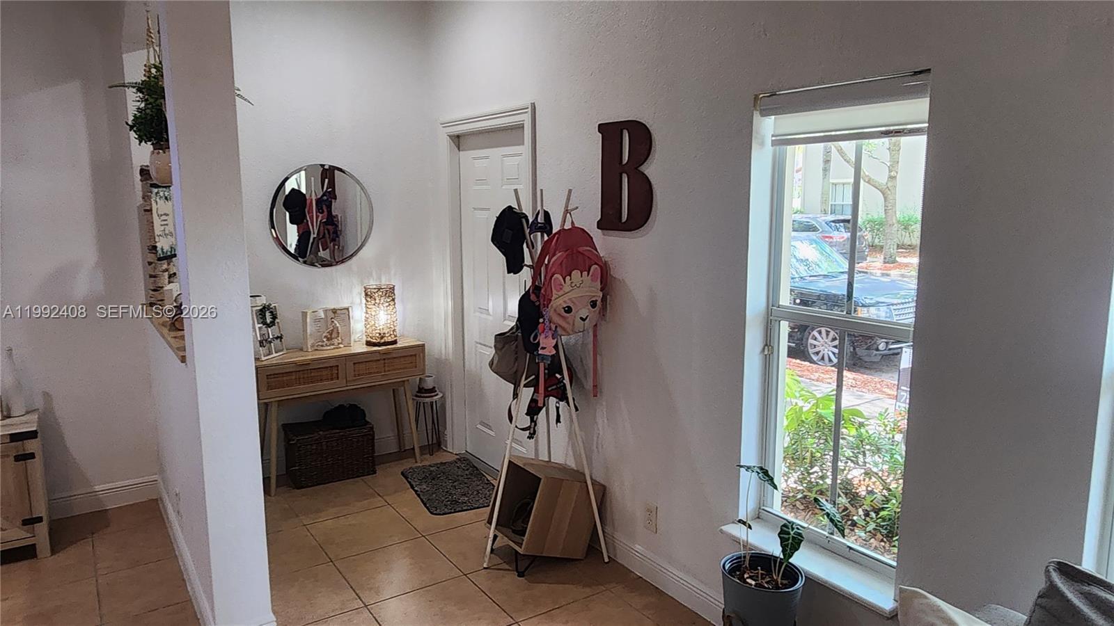 2607 Southwest 99th Way Miramar, FL 33025 - Photo 5 of 50 a view of a hallway with washer and dryer on the wall