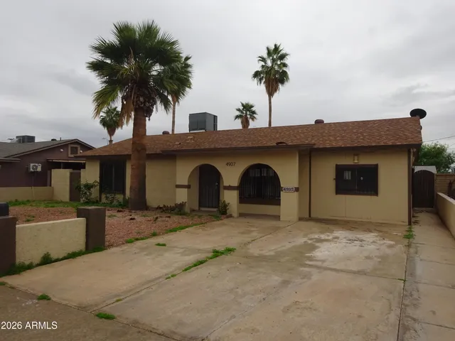 a view of a house with a yard and potted plants