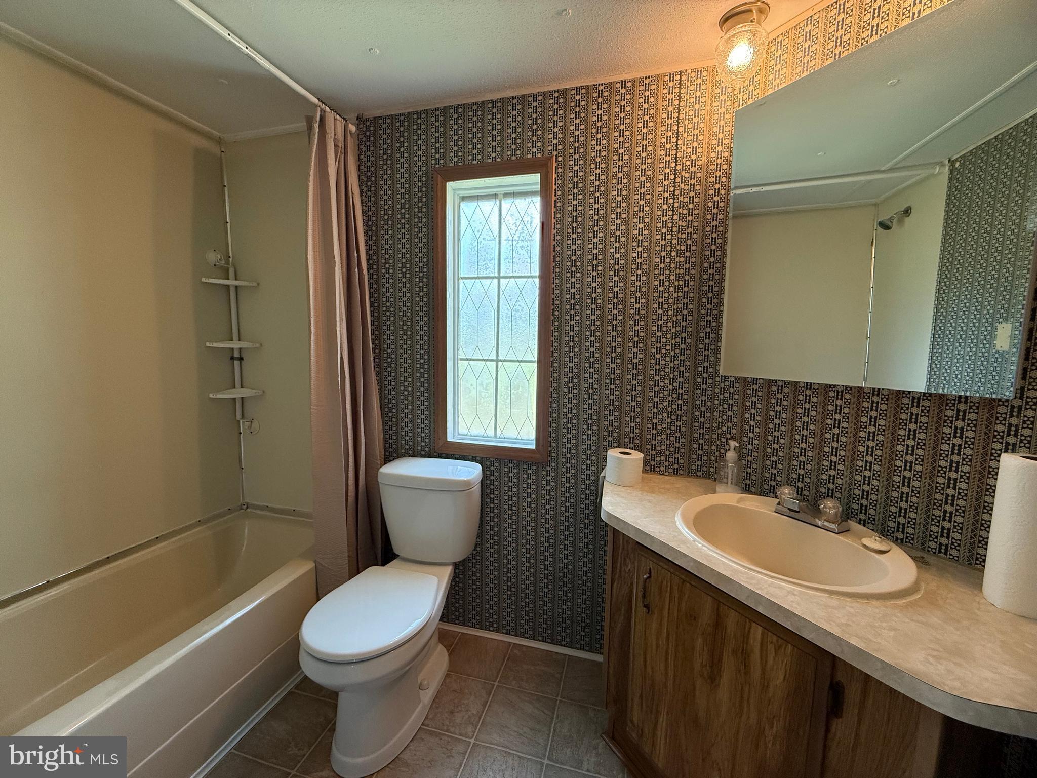 192 AA Rogers Road Augusta, WV 26704 - Photo 19 of 34 a white toilet sitting next to a bathroom sink