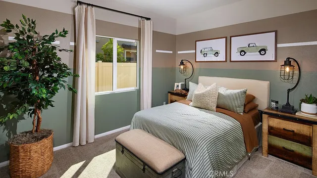 a bedroom with a bed and a potted plant