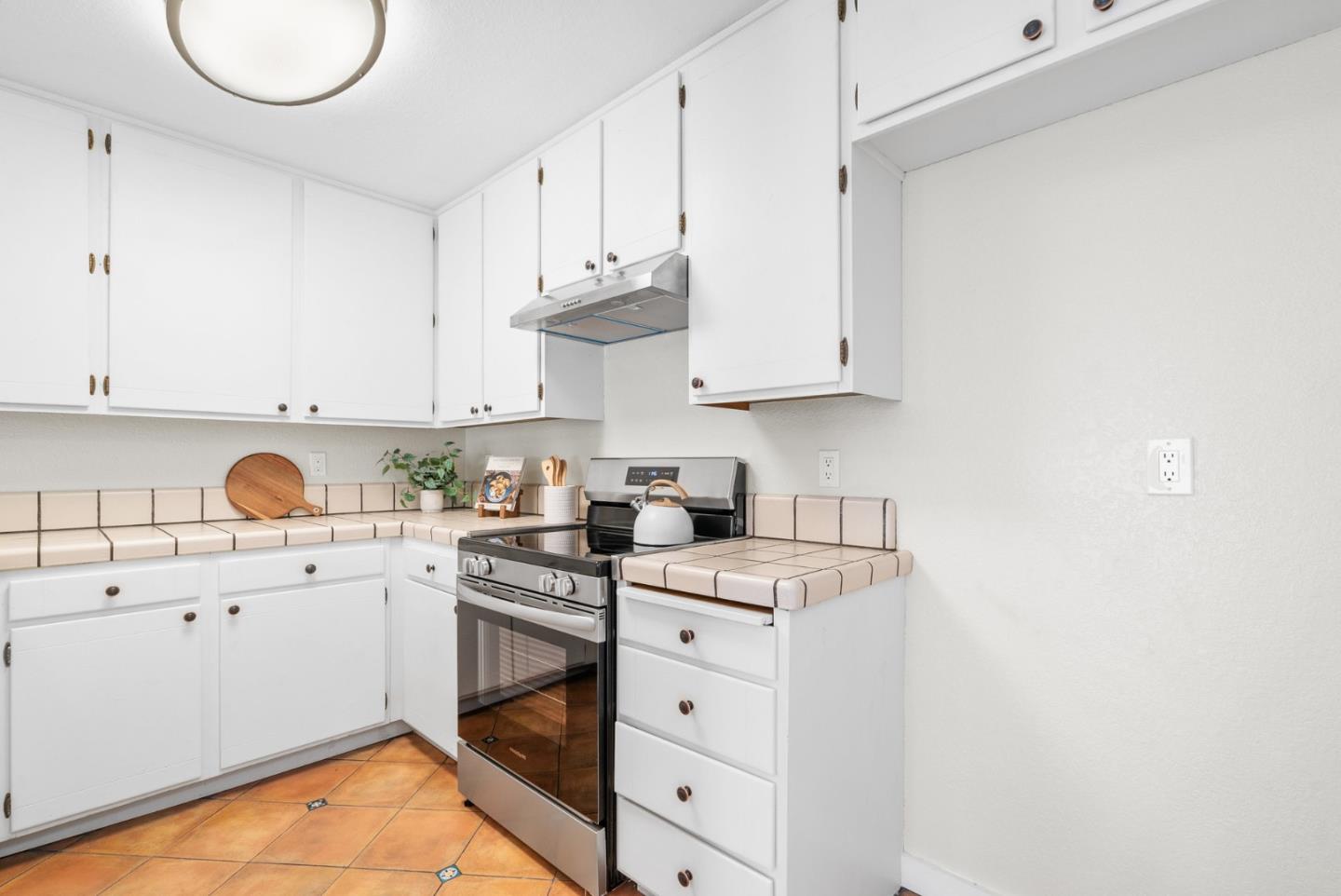 6101 Sheraton Place Aptos, CA 95003 - Photo 23 of 47 a kitchen with white cabinets appliances and a sink