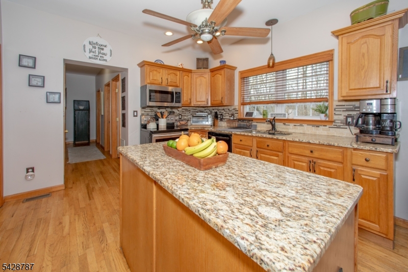 70 Holland Road Wantage, NJ 07461 - Photo 6 of 35 a kitchen with stainless steel appliances granite countertop a sink stove and refrigerator