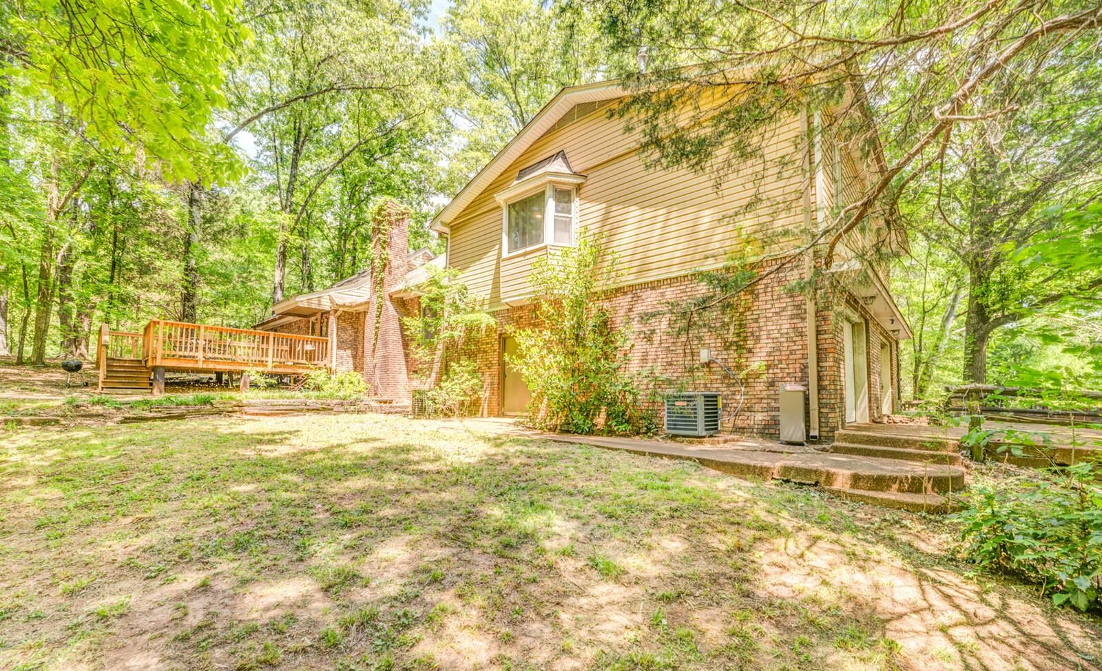8651 Baylor Road Bartlett, TN 38002 - Photo 26 of 29 a view of a large house with a large trees and a big yard