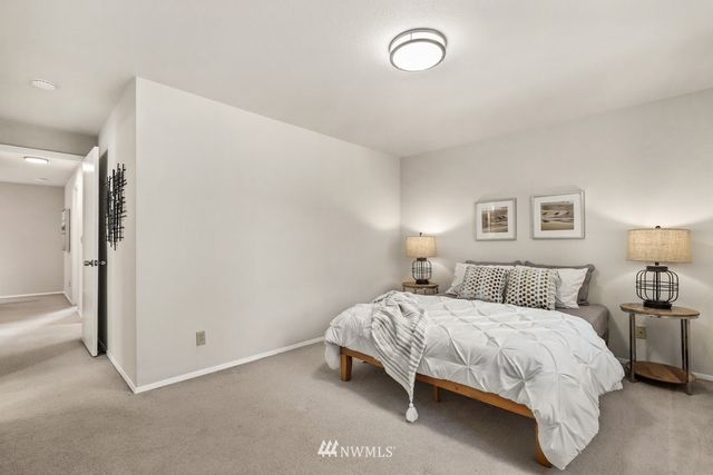 a bedroom with a bed and a night stand