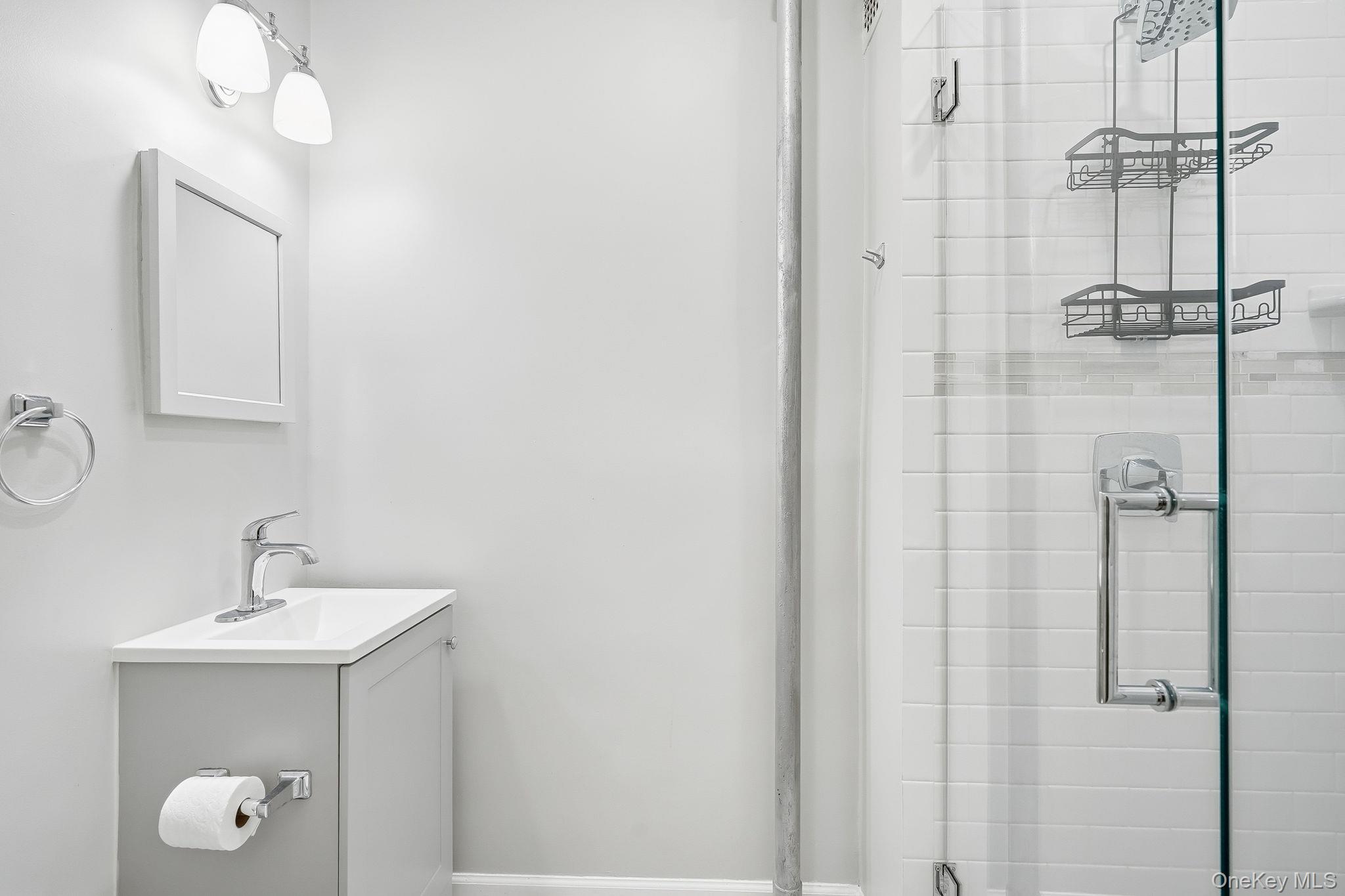 2 Overlook Road, Unit 3C3 White Plains, NY 10605 - Photo 22 of 36 a bathroom with a sink a mirror and shower
