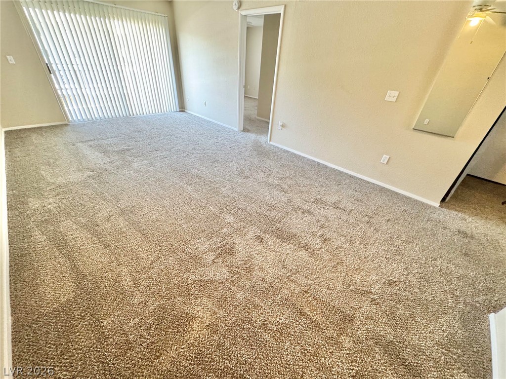 8070 West Russell Road, Unit 2121 Las Vegas, NV 89113 - Photo 3 of 22 A well-lit interior space awaits your personal touch with soft, neutral carpeting.