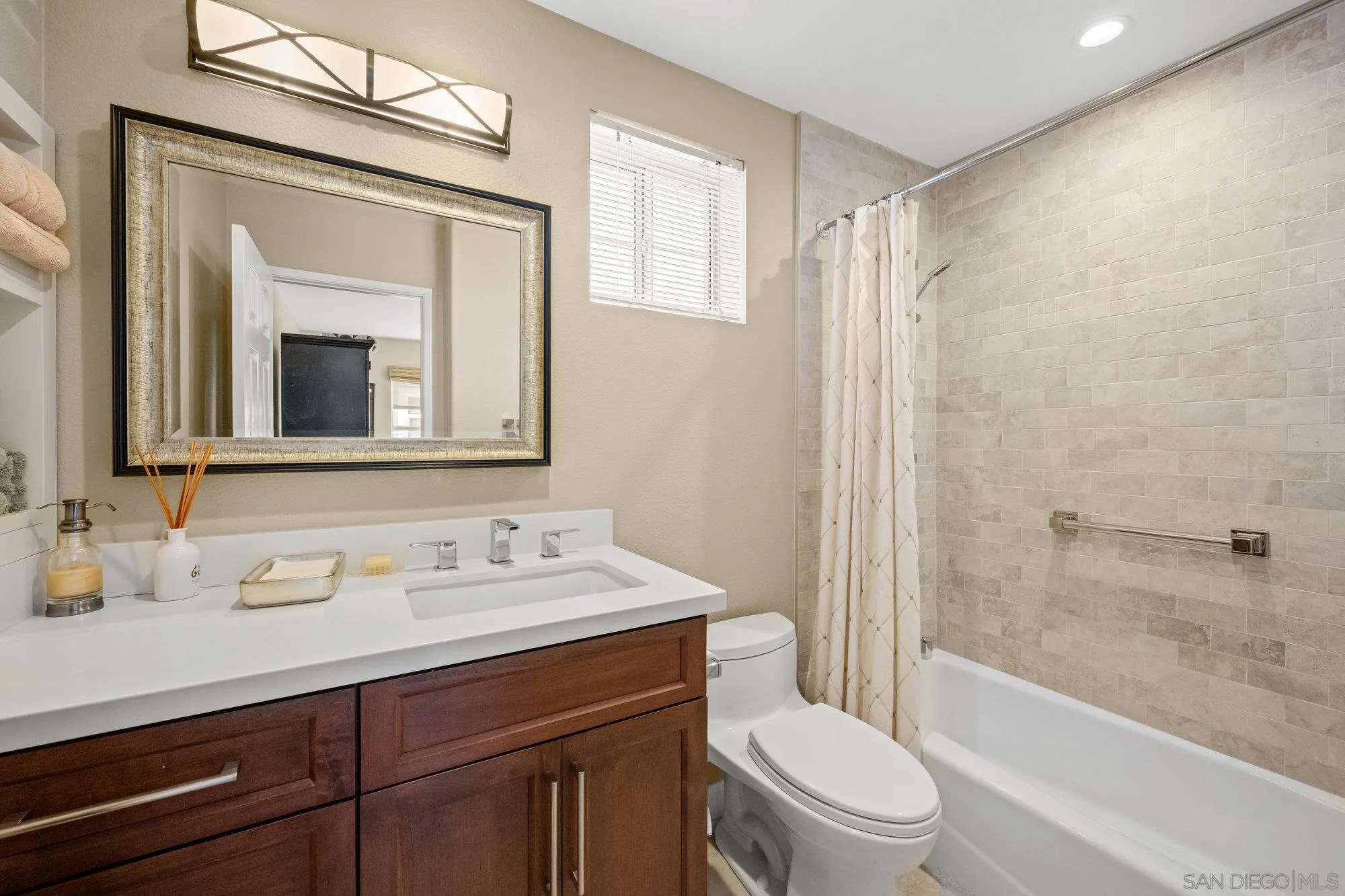 6845 Adolphia Drive Carlsbad, CA 92011 - Photo 16 of 33 a bathroom with a toilet a sink a bathtub and a mirror