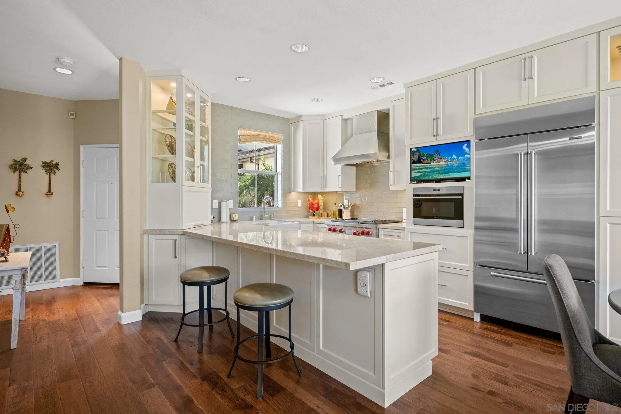 6845 Adolphia Drive Carlsbad, CA 92011 - Photo 2 of 33 a kitchen with stainless steel appliances granite countertop a table chairs refrigerator and sink