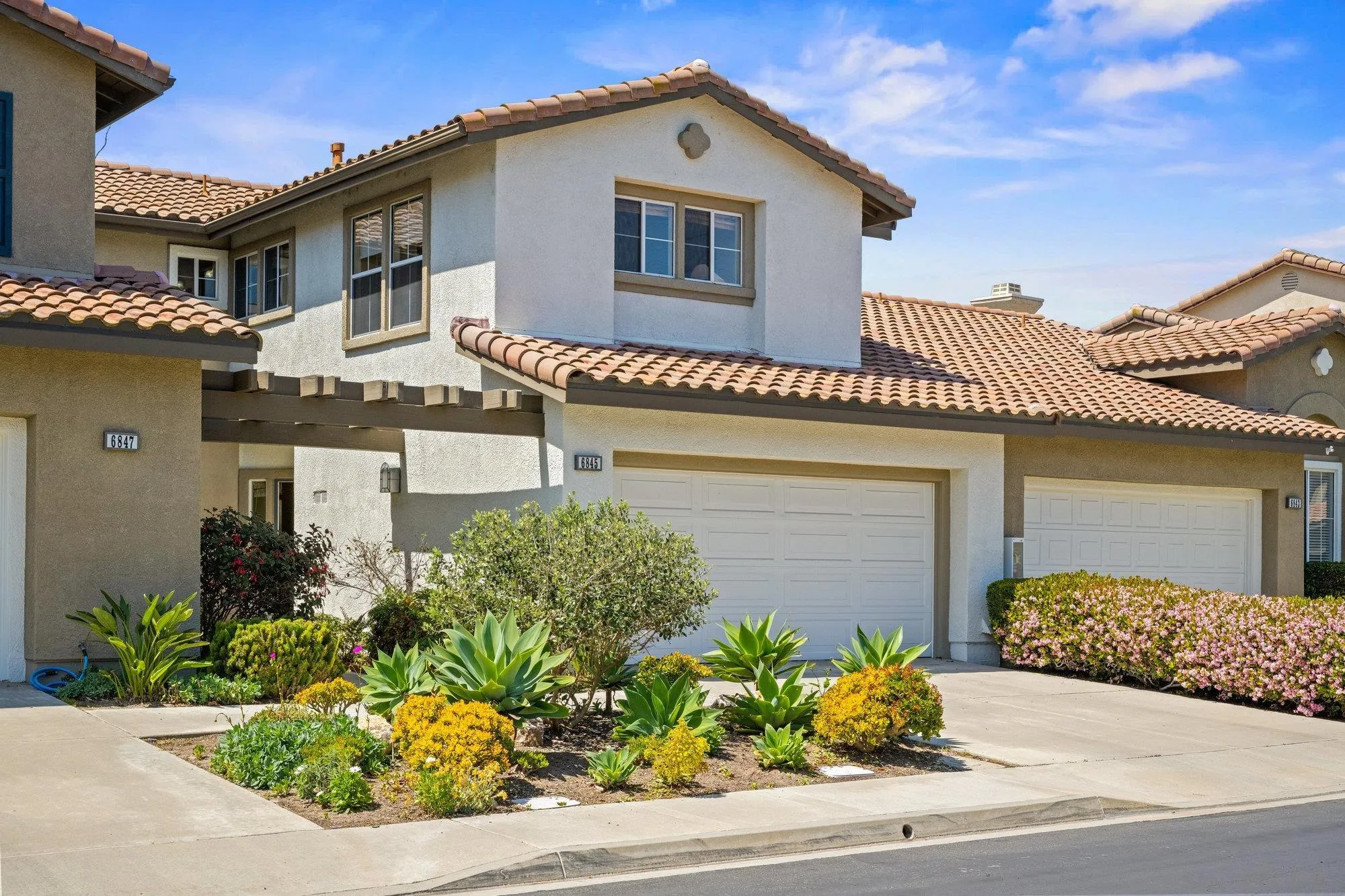 6845 Adolphia Drive Carlsbad, CA 92011 - Photo 22 of 33 a view of a house with a yard and potted plants