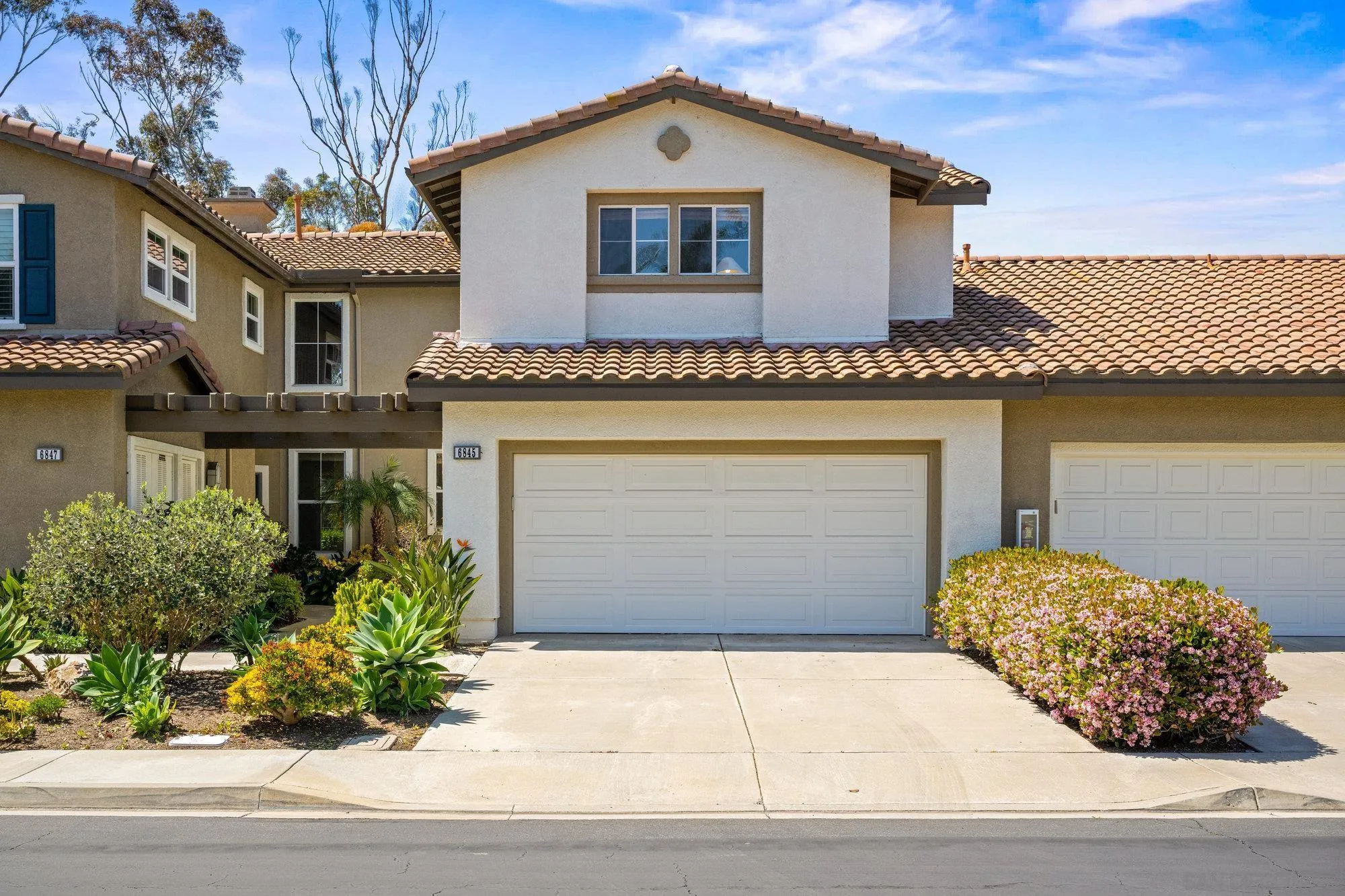 6845 Adolphia Drive Carlsbad, CA 92011 - Photo 23 of 33 a front view of a house with a yard and garage