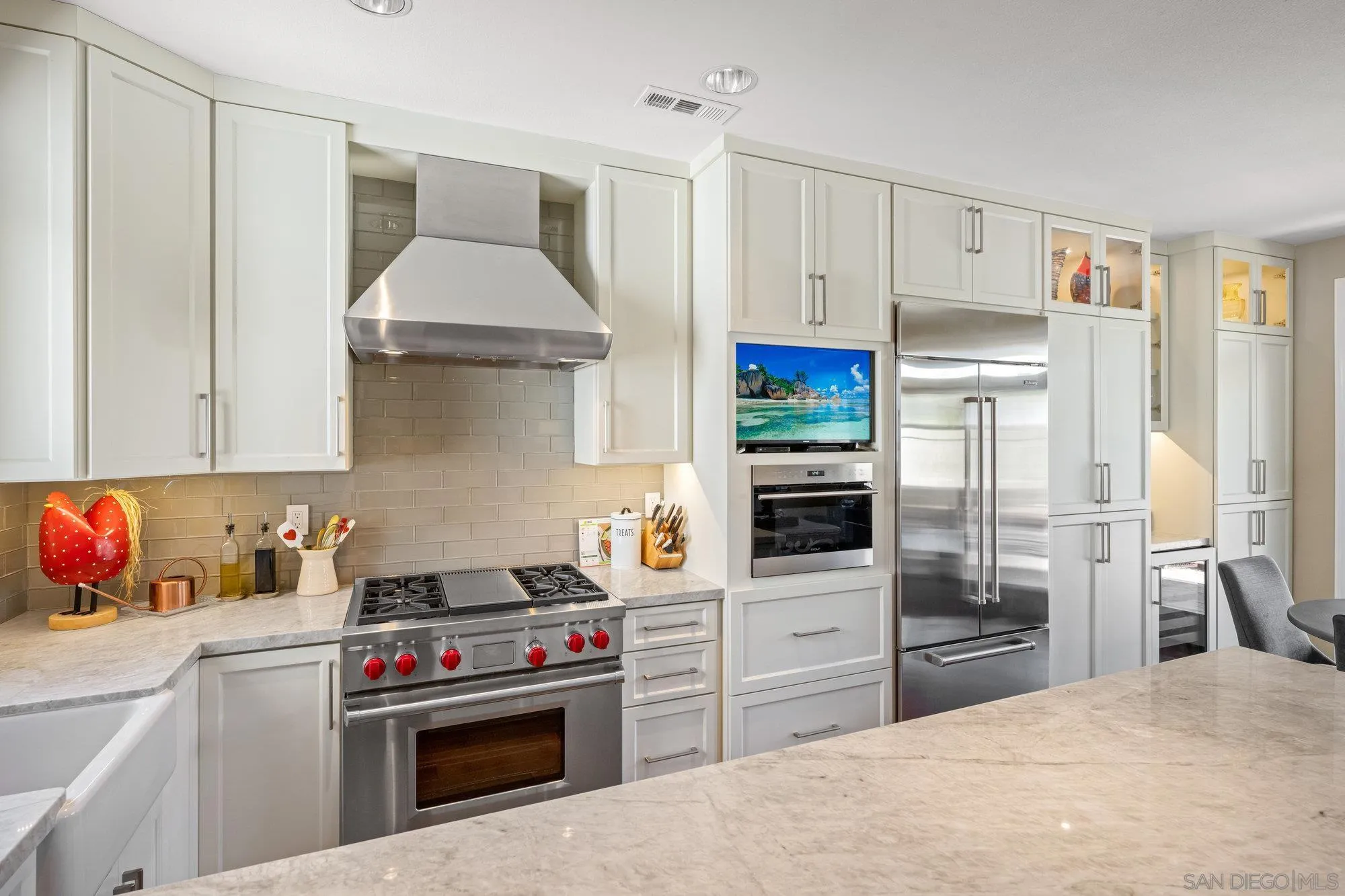 6845 Adolphia Drive Carlsbad, CA 92011 - Photo 5 of 33 a kitchen with stainless steel appliances a stove a refrigerator and a sink