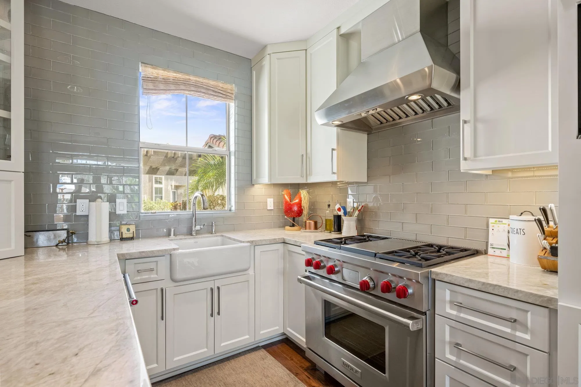 6845 Adolphia Drive Carlsbad, CA 92011 - Photo 6 of 33 a kitchen with granite countertop a stove sink and cabinets