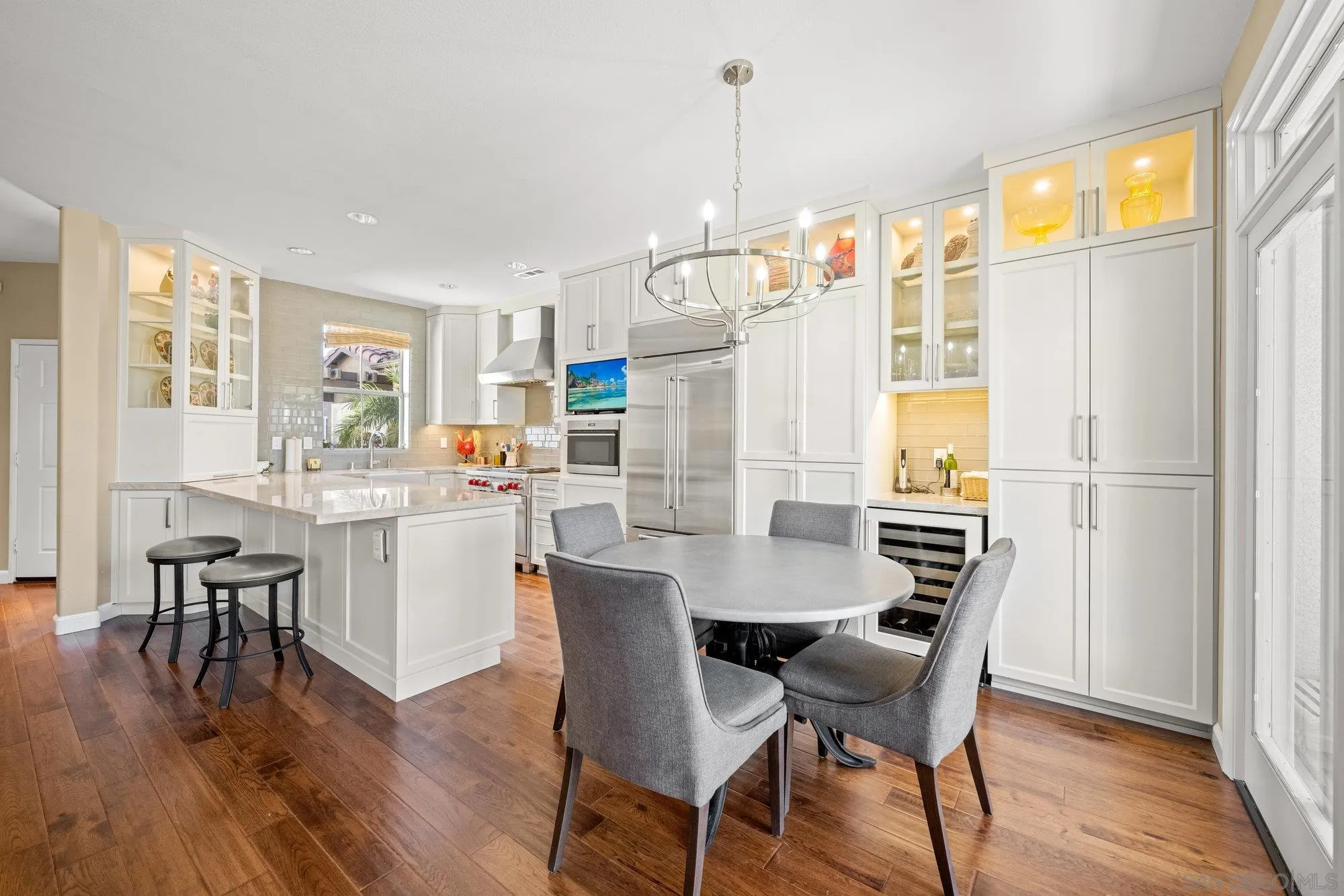 6845 Adolphia Drive Carlsbad, CA 92011 - Photo 7 of 33 a dining room with furniture a chandelier and wooden floor