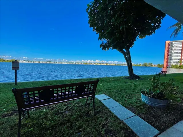 a view of swimming pool with outdoor seating and plants