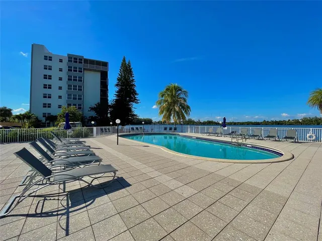 a view of a lake with chairs