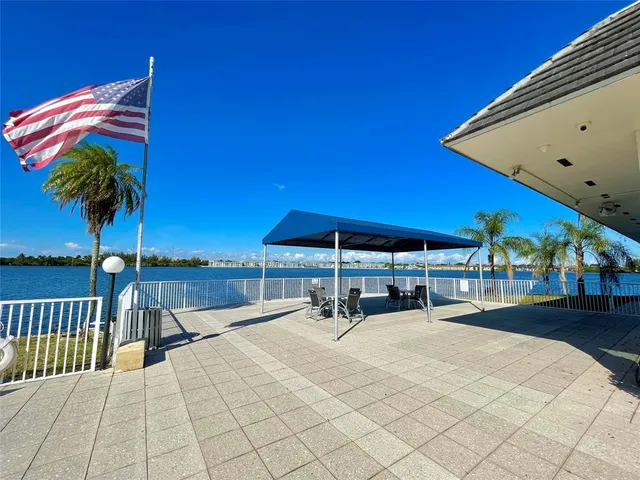 a front view of a house with swimming pool and ocean view