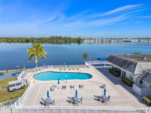a view of a swimming pool with a table and chairs