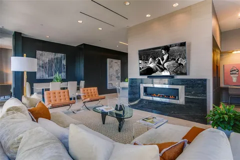 a living room with furniture kitchen view and a fireplace