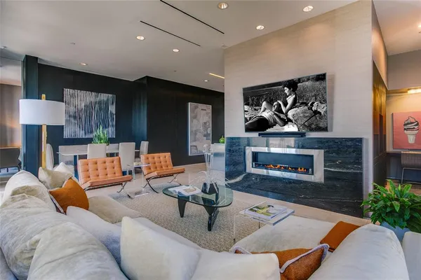 a living room with furniture kitchen view and a fireplace
