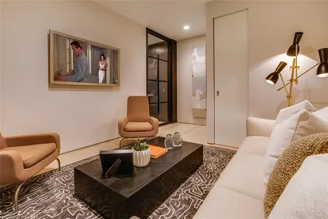 a living room with furniture and painting on the wall