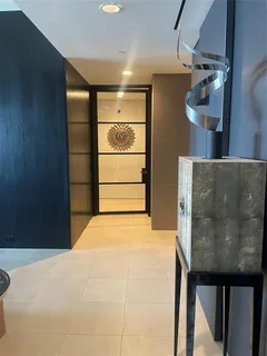 a kitchen with furniture and a refrigerator