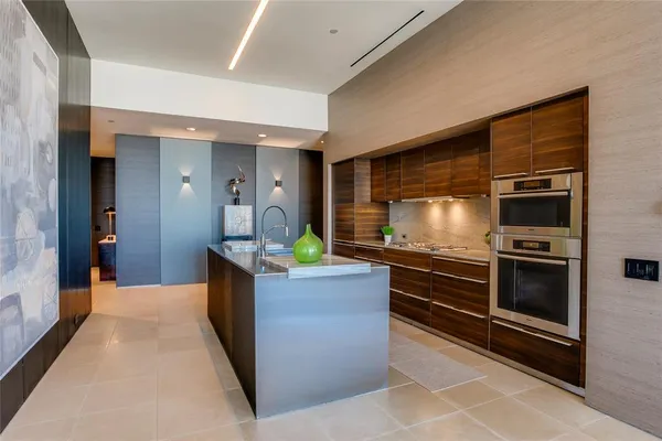 a kitchen with stainless steel appliances granite countertop a sink and a stove
