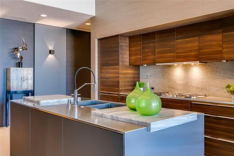 a kitchen with sink and cabinets