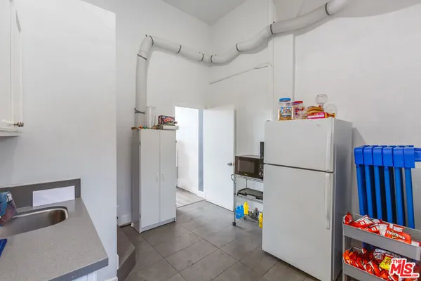 a white refrigerator freezer sitting inside of a kitchen