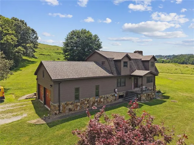 a aerial view of a house with swimming pool garden and balcony