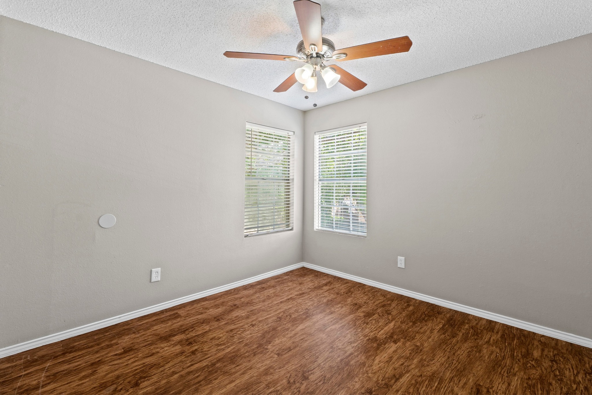 4208 Duval Road, Unit C Austin, TX 78759 - Photo 22 of 28 Spare room with wood finished floors, a textured ceiling, and a ceiling fan