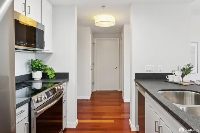 a kitchen with stainless steel appliances granite countertop a sink and a stove