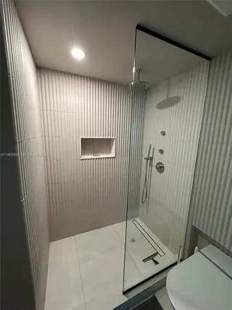 a bathroom with a shower and toilet