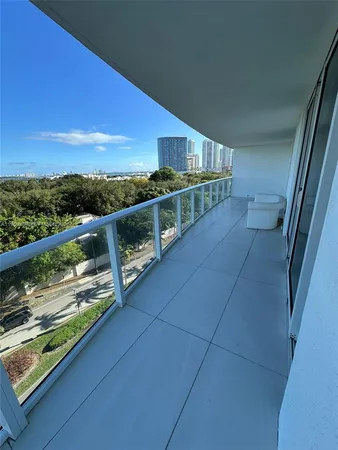 a view of balcony with furniture and city view