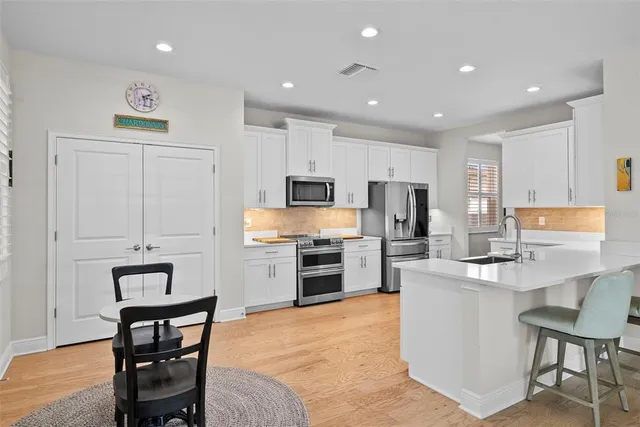 a kitchen with cabinets stainless steel appliances and a counter space