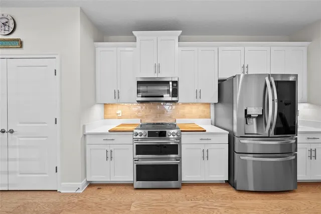 a dining room with furniture a chandelier and wooden floor