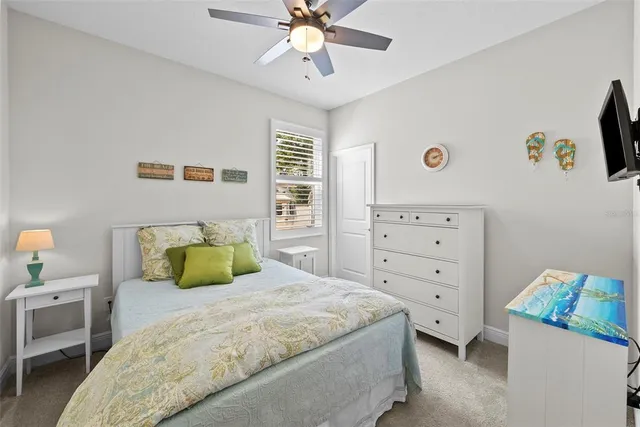 a living room with furniture a ceiling fan