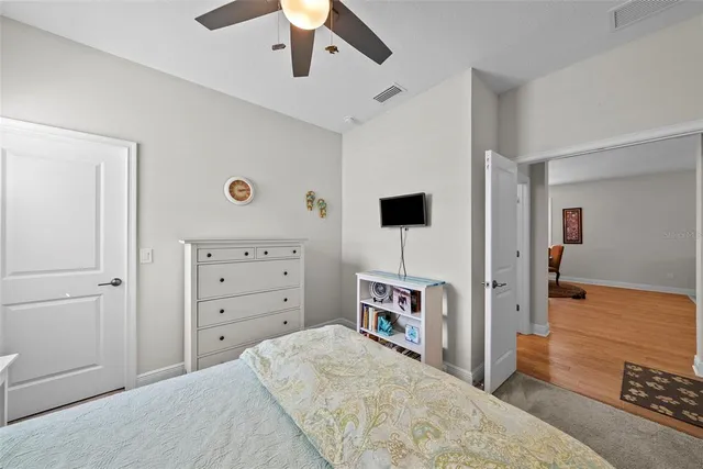 a bedroom with furniture and a ceiling fan