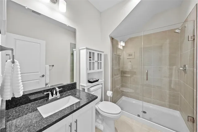 a bedroom with a bed and a television