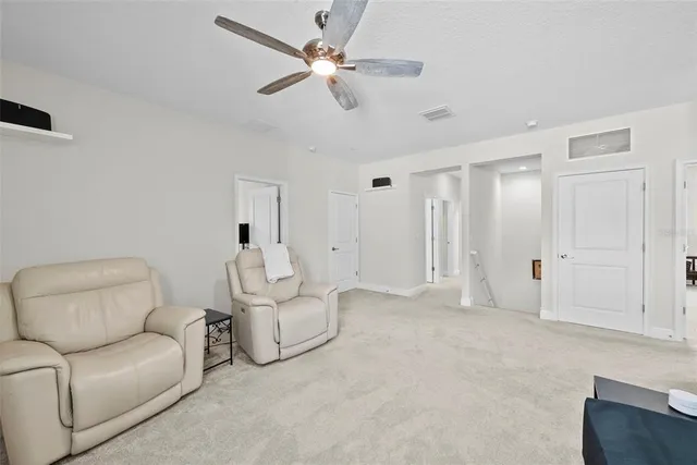 a work room with furniture and a flat screen tv