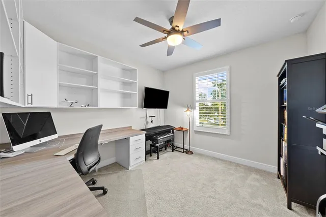 a view of swimming pool with a table and chairs under an umbrella