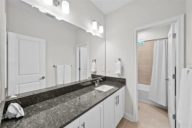 a view of a patio with table and chairs under an umbrella